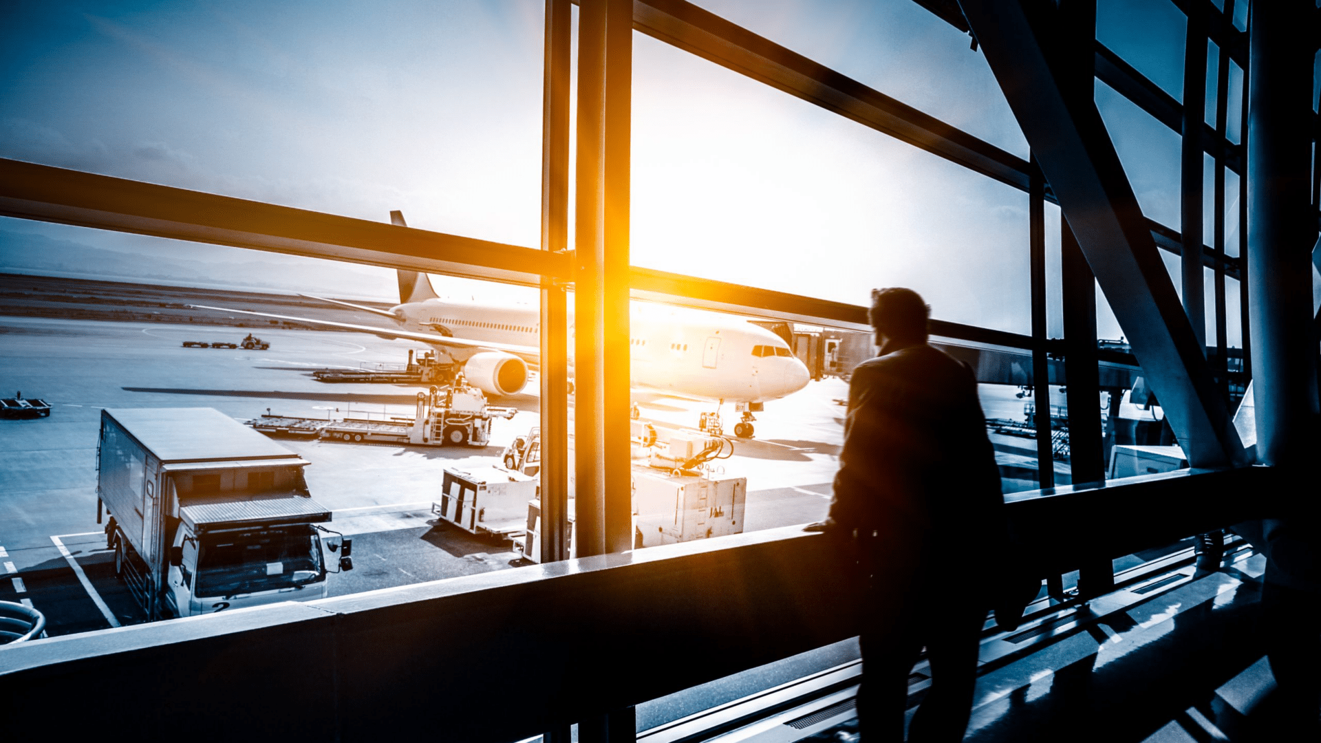 Person standing at window at an aiport