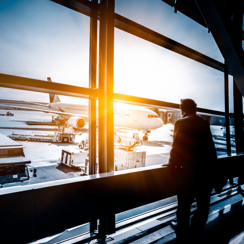 Person standing at window at an aiport