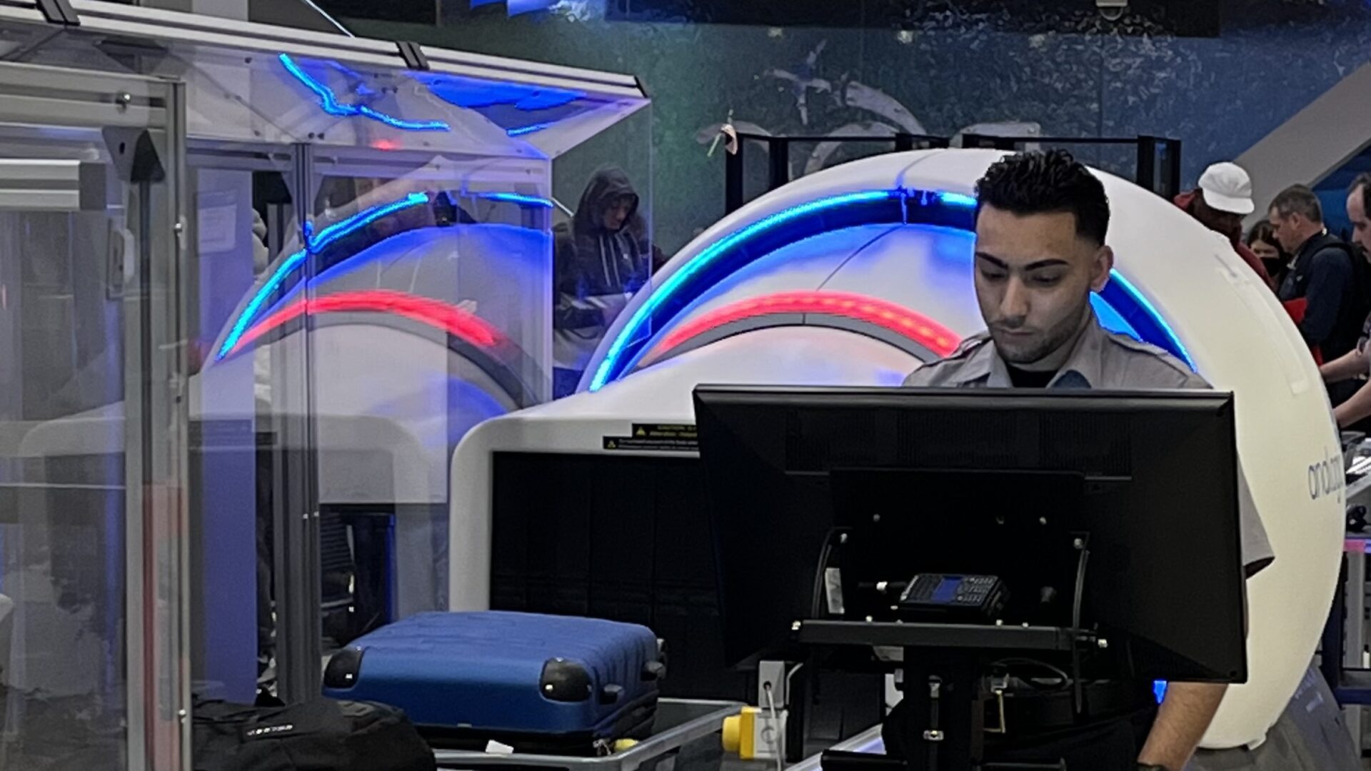 Photo of VMD employee using screening technology at airport security