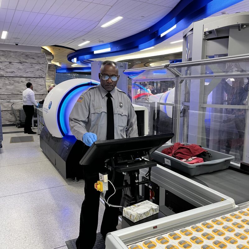 VMD employee using screening technology at a security line in an aiport