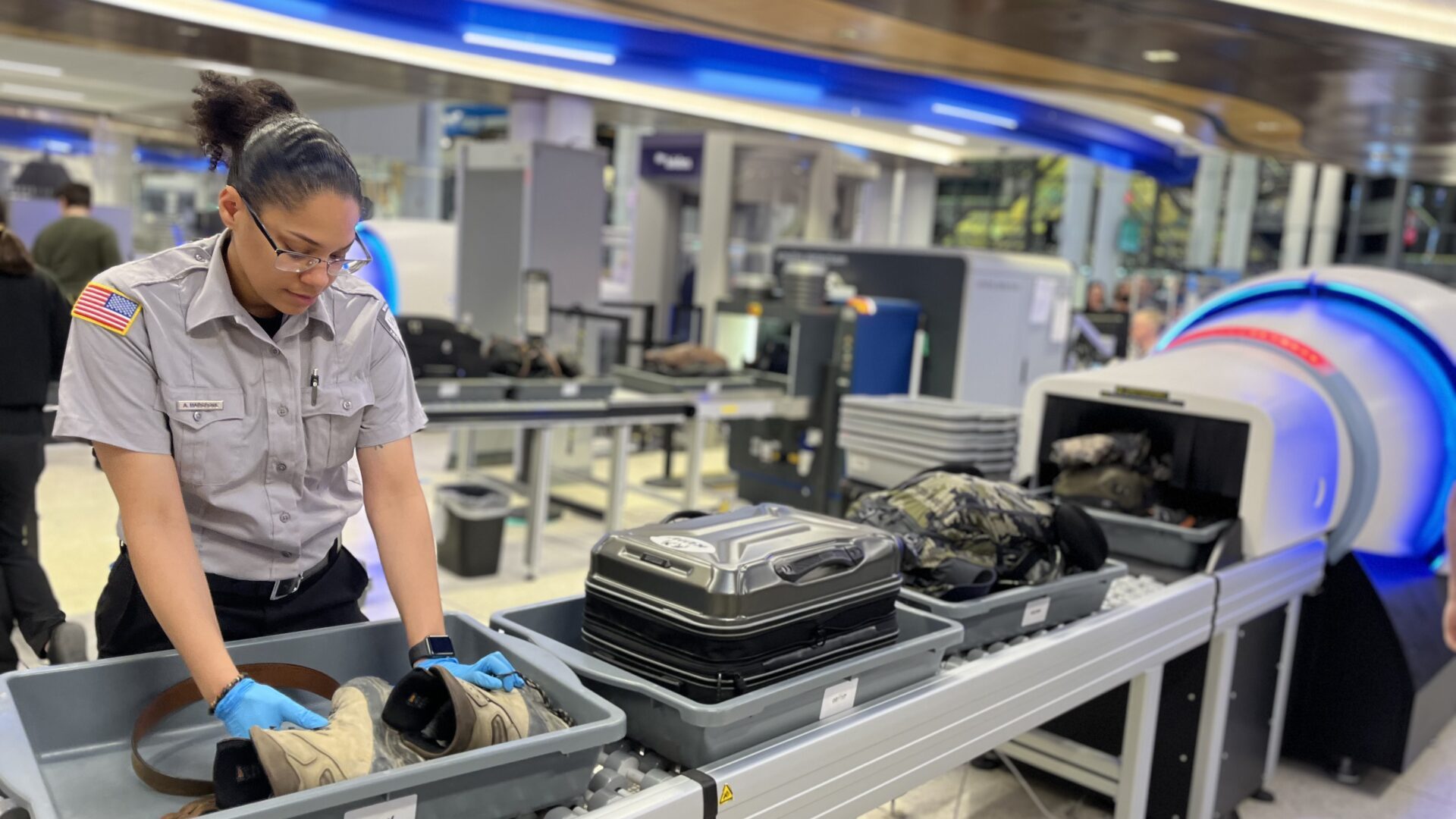 VMD security employee checks passenger items